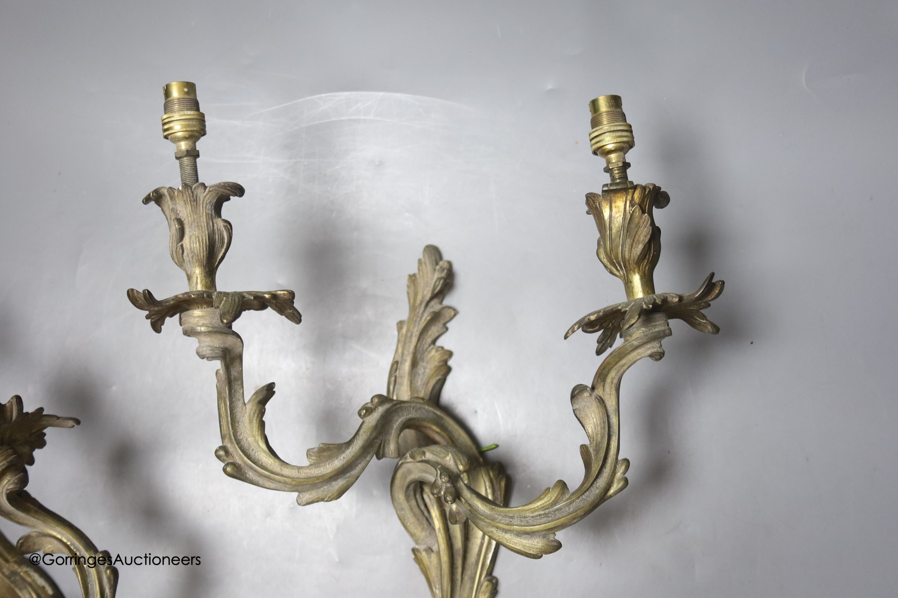 A pair of brass two branch wall lights, height 32cm